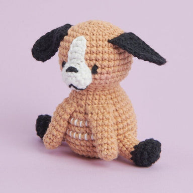 Crocheted dog toy on a light purple background