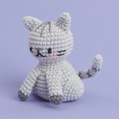 Crocheted cat toy on a light purple background