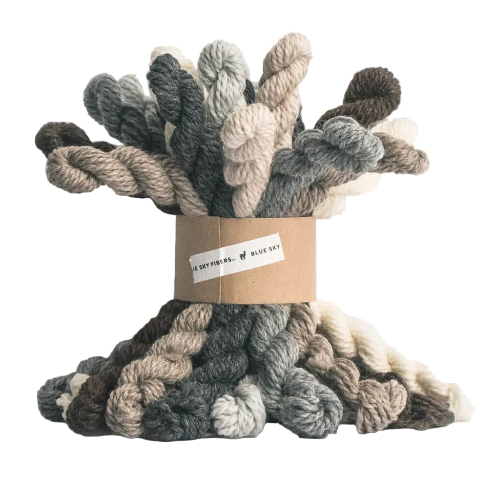 Spool of multicolored yarn on a white background