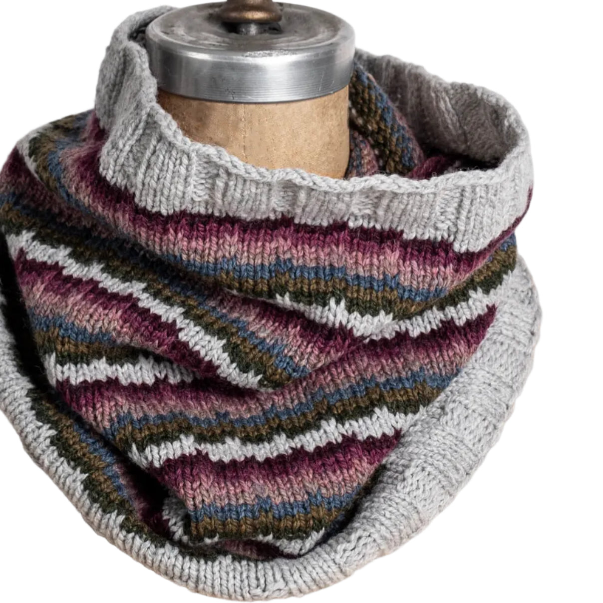 Knitted cowl with multicolor pattern on a mannequin against a white background