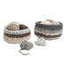 Two round crocheted yarn baskets in neutral tones of gray, beige, and brown, displayed on a clean white background with loose balls of yarn in front.