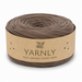 A roll of Yarnly faux leather T-shirt yarn in a taupe-brown color, wrapped in a kraft paper band with the brand name 'YARNLY' printed on it, set against a plain white background.