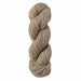 Coiled skein of beige yarn on a white background